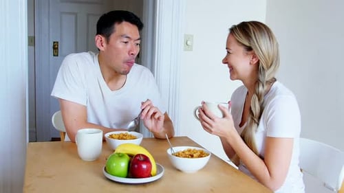 Couple Eating Breakfast and Talking at Home