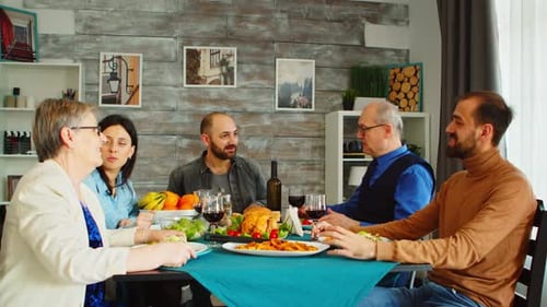 Family Gathering Around Dinner Table at Home