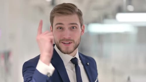 Professional Man Talking and Gesturing in Office