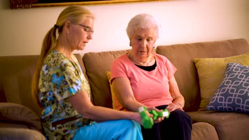 Senior Woman Exercising with In-Home Caregiver