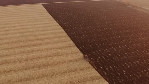 Drone View of Tractor Plowing Farm Field