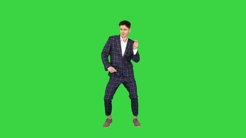 Happy Successful Businessman Dancing In a Crazy Way on a Green Screen, Chroma Key.