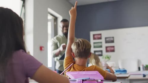 Young Students Eagerly Raise Hands in Classroom