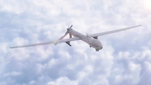 Military Drone Flying in Cloudy Sky