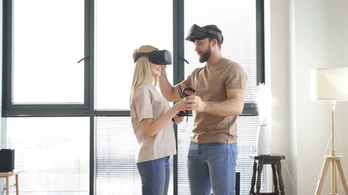 Couple Experiencing Virtual Reality Headsets at Home