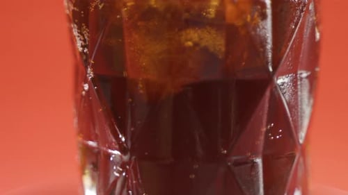 Ice Cubes Dropping Into Glass Soda Drink