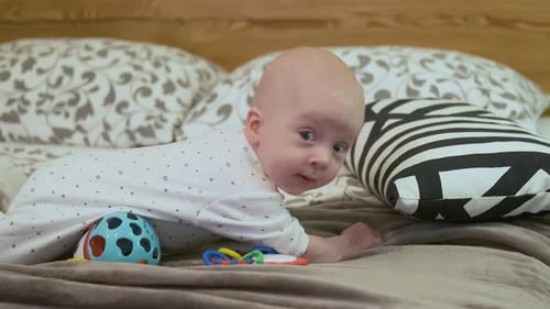 Cute Infant Lying on Stomach on Bed