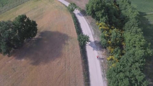 Man cycling with mountain bike on countryside road