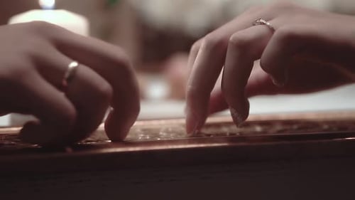 Young People Sit in a Restaurant and Touch Each Other Gently Closeup Slow Motion