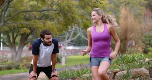 Couple warming up in forest
