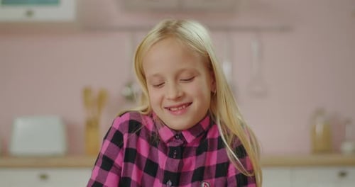 Cute Blonde Little Girl Enjoy Eating Sweet Pink Donut at Pink Kitchen, Smiling Female Child Biting