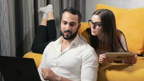 Young Adults Relaxing at Home with Technology