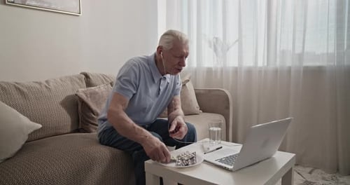 Senior Man Telehealth Call on Laptop