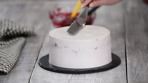 Cake Icing Being Smoothed on Delicious Pastry