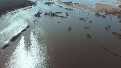 On a Sunny Spring Day the Camera Flies High Over a Flooded Area of the Field