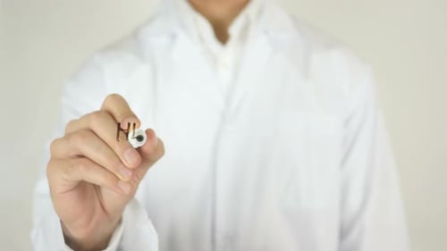 Hand Writes Healthy Living on Glass