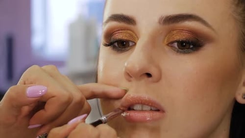Makeup Artist Applying Lipstick