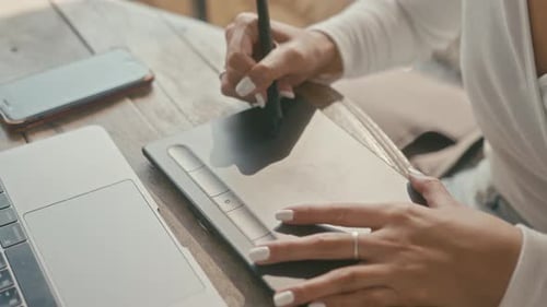 Artist Using Tablet for Digital Drawing