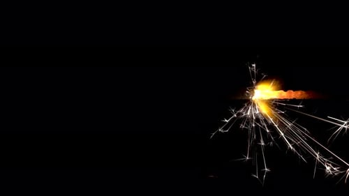 Sparkler Emits Gold Sparks in the Night