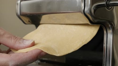 Kitchen helper machine for pasta 4K 2160p 30fps UltraHD footage - Close-up of dough processing for I