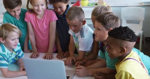 Group of kids using laptop in the class