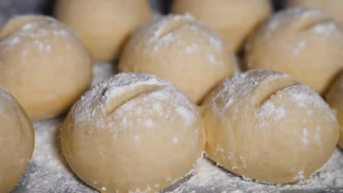 Raw Bread Dough Balls on Baking Sheet