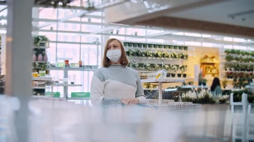 Woman with a Trolley in a Flower Shop