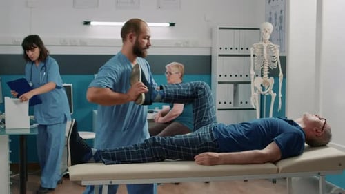 Therapist Using Legs Raise Exercise to Stretch Muscles and Crack Bones