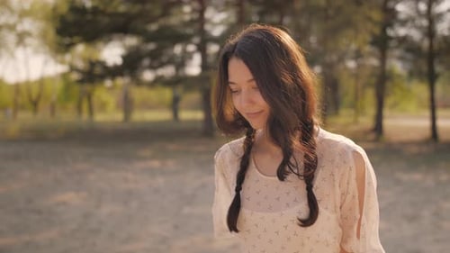 Happy Woman in Forest Enjoying Nature. Cute Young Girl Walking Outdoors