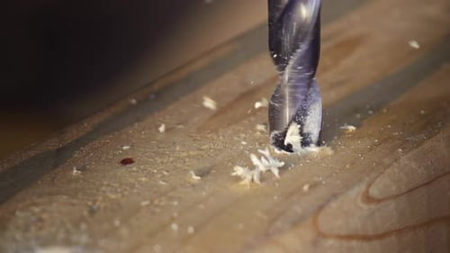 Drill Bit Drilling Hole in Wood Creates Shavings