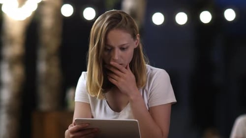 Worried Woman Uses Tablet at Night