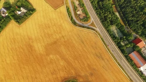 Golden Field Beside a Highway Aerial View