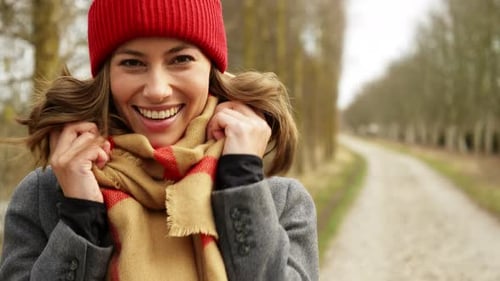 Smiling Woman with Red Hat Outdoors in Winter