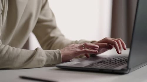Hands Typing on Laptop Computer Keyboard