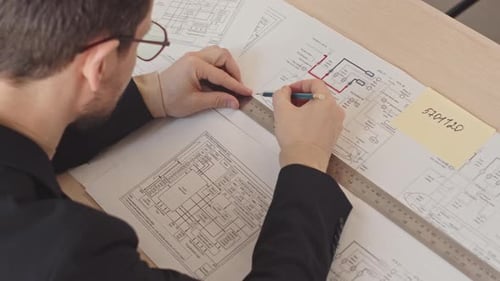 Design Engineer Drawing Project Scheme at Table