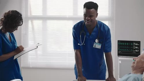 Senior Patient on Bed Talking to 2 African American Doctor in Hospital Room Health Care and