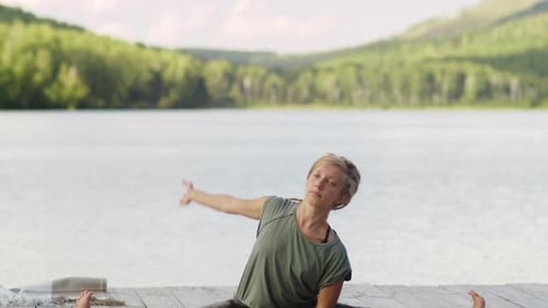 Flexible Woman Doing Yoga Stretches on Lake Pier