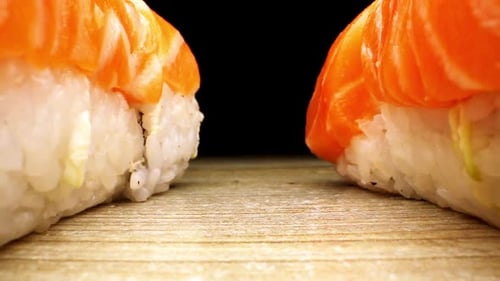 Delicious Sushi with Rice and Red Fish Stand on Brown Board