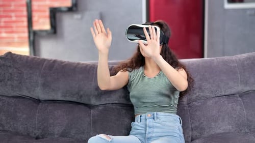 Woman Using VR Headset on a Couch
