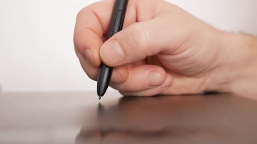 a Male Designer Works with Laptop on Graphics Tablet Photographer Photo Retouching and Processing