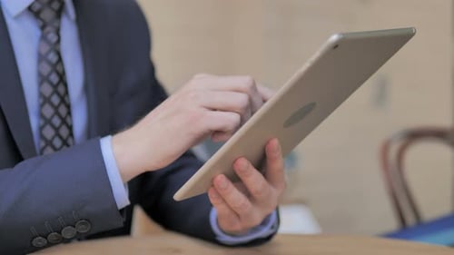 Close Up of Businessman Hands Using Tablet