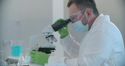 Scientist Uses Microscope in Bright Modern Laboratory