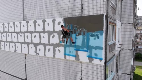 Man Applies Coating to Building Insulation