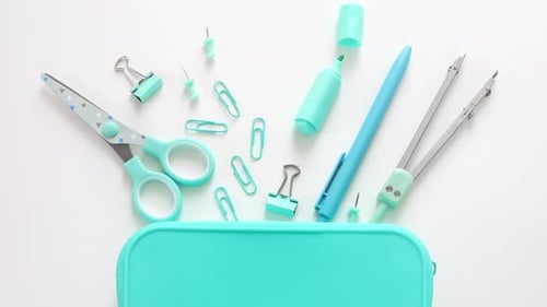 Blue school supplies, accessories on the white table.