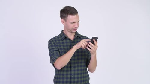 Studio Shot of Happy Hipster Man Using Phone