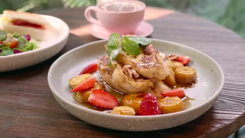 French Toast with Caramelized Bananas and Strawberries