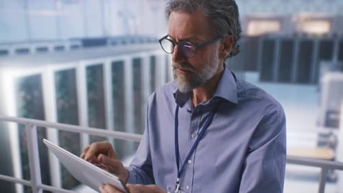 Mature Man Using Tablet in Data Center