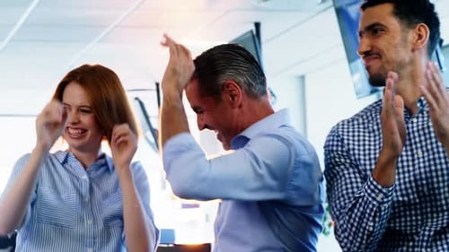 Colleagues Celebrating Success in Bright Office