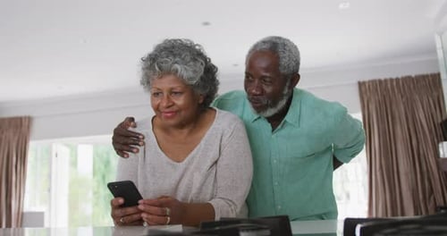 Senior Man Surprises Woman with Roses at Home