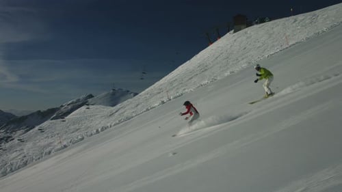 Skiers Descending a Mountain Slope in Winter